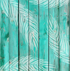 Palm Leaf Wall Stencil Whitewashed onto an aqua colored wooden fence